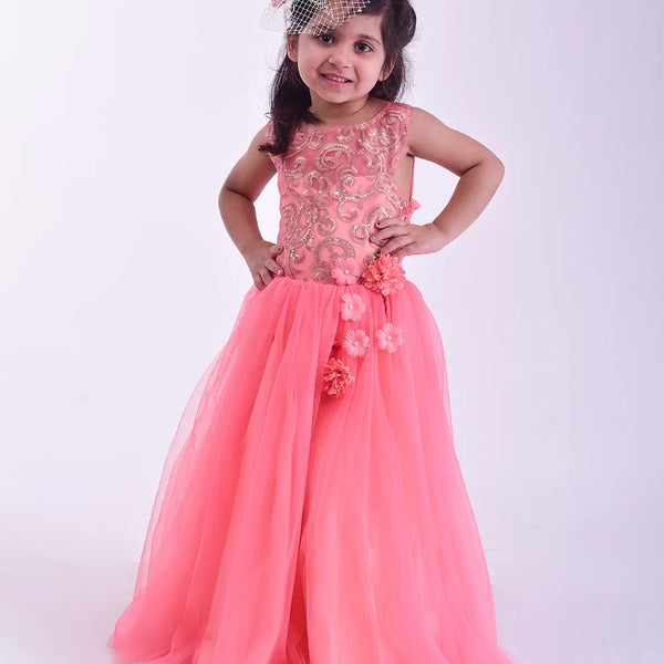 Young girl wearing a pink floral dress against a white background