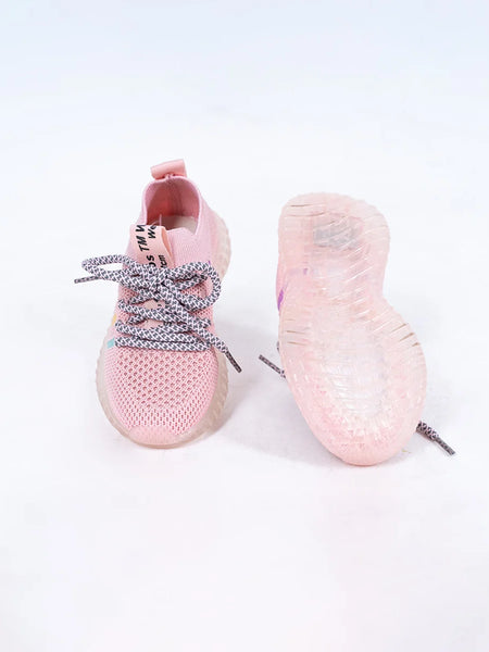 Close-up of trendy girls' pink mesh sneakers with lace-up design and transparent sole, Jaipur

