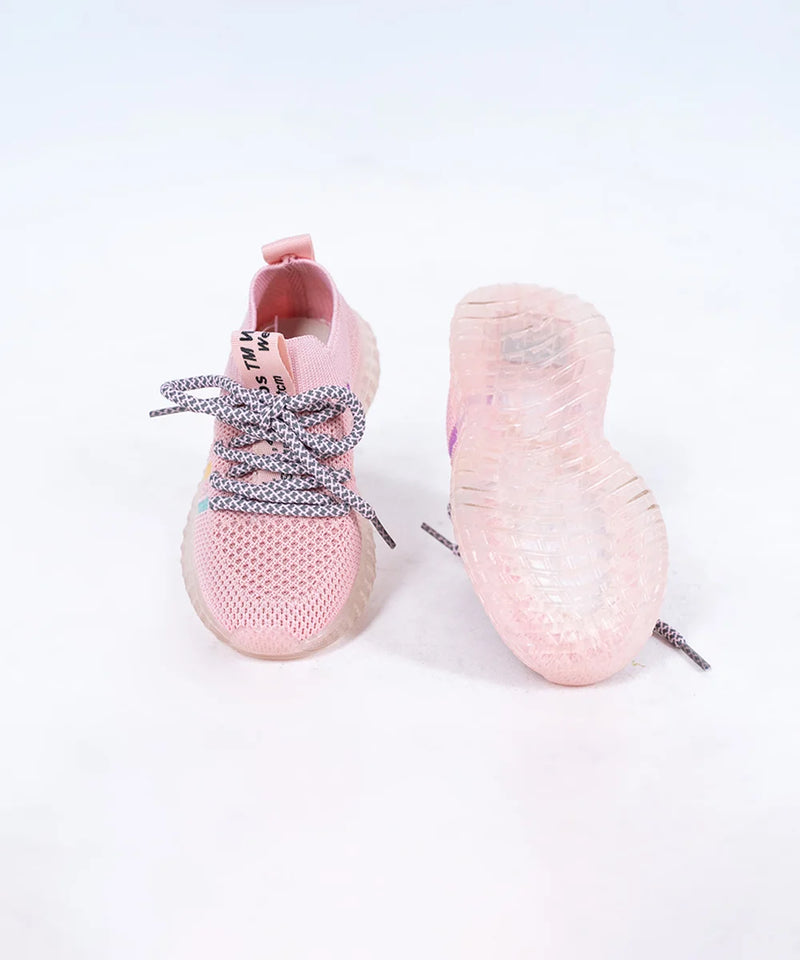 Close-up of trendy girls' pink mesh sneakers with lace-up design and transparent sole, Jaipur

