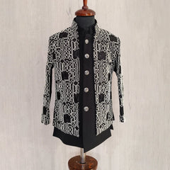 Black and white patterned jacket on a mannequin against a light background