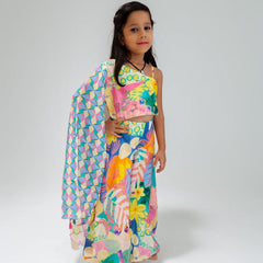 Young girl wearing a colorful outfit with a patterned shawl on a white background