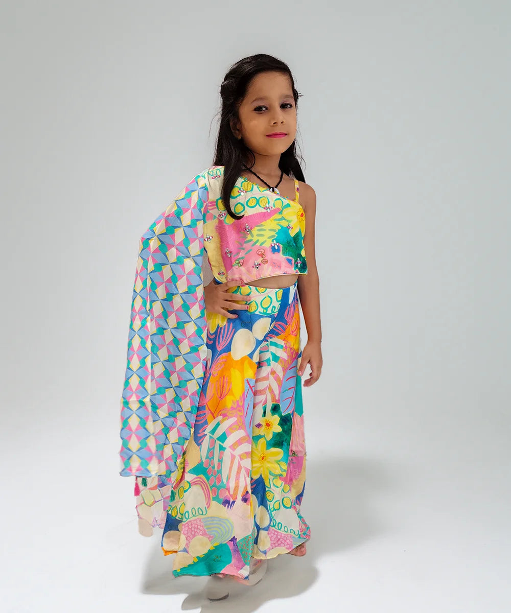 Young girl wearing a colorful outfit with a patterned shawl on a white background