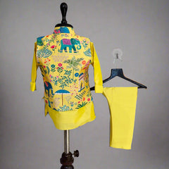 Colorful outfit with yellow pants and patterned shirt on mannequin against plain background