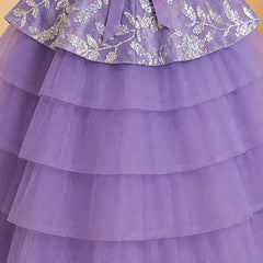 A close-up of a purple tiered tulle dress or skirt with a matching waist sash and silver floral embroidery on the upper ruffled section.