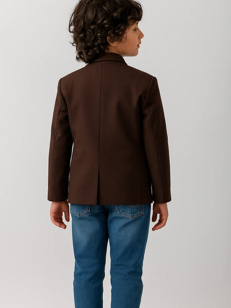 Child wearing a brown jacket and blue jeans on a white background