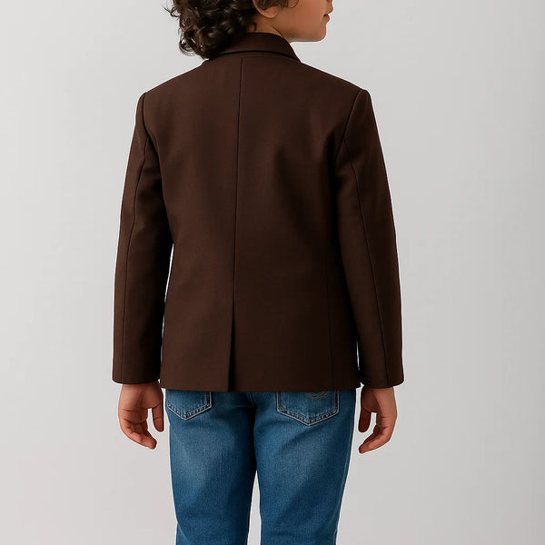 Child wearing a brown jacket and blue jeans on a white background