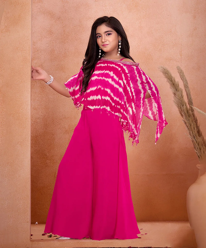 Woman wearing a pink and white tie-dye top with a matching skirt against a beige background