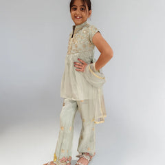 Young girl wearing a traditional outfit with a plain background