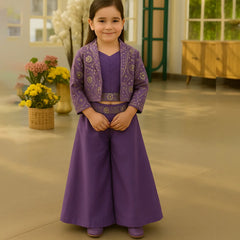 Young girl in a purple traditional outfit standing indoors with flowers in the background