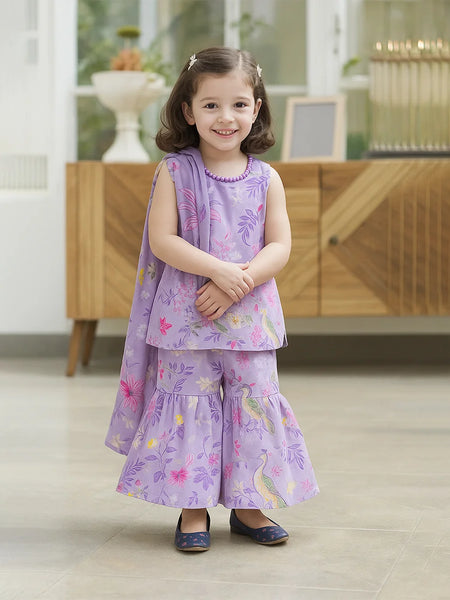 baby girl in a purple floral dress standing indoors