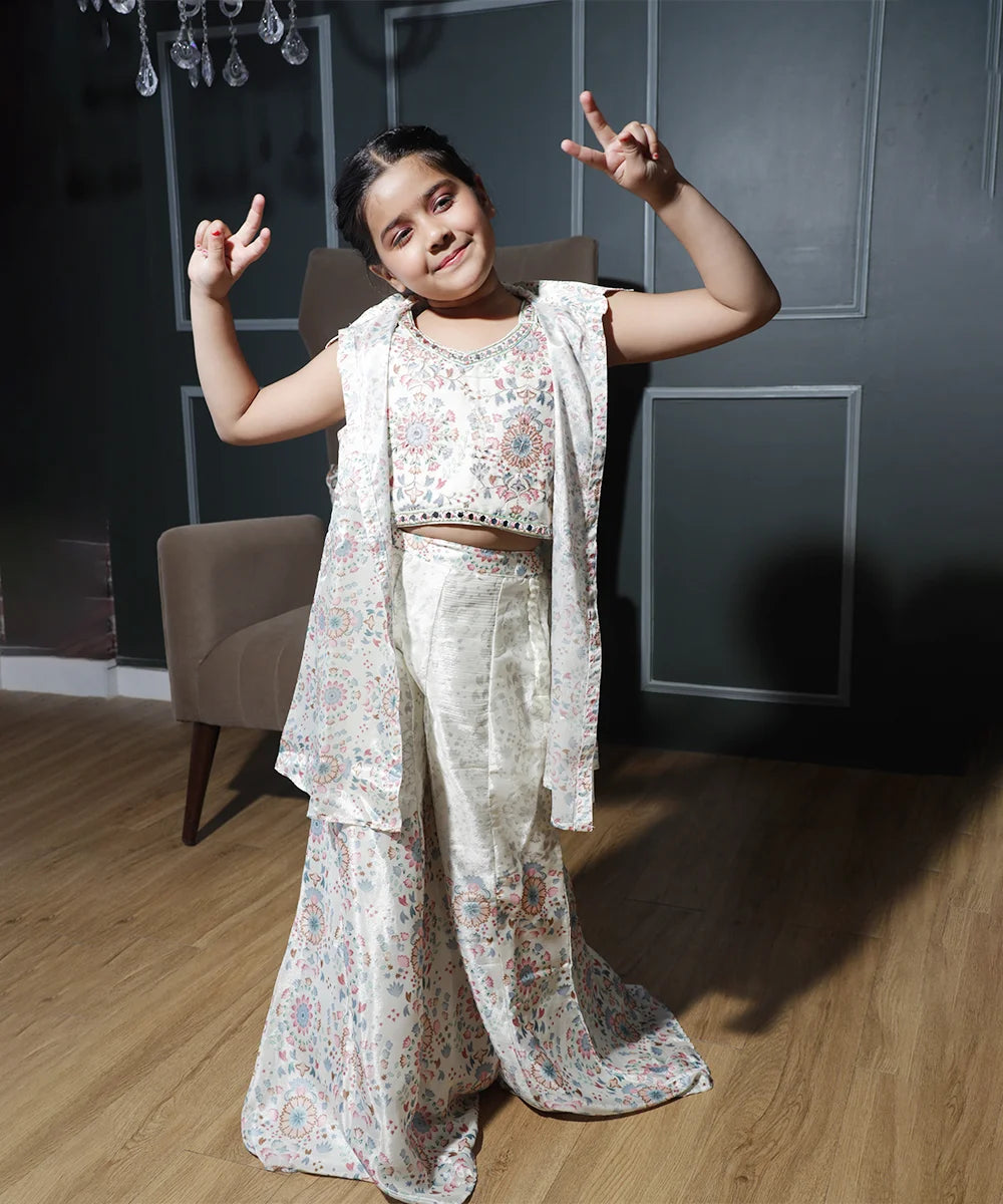 This cream colored printed palazzo set consists of a crop top with a back hook closure, a jacket and a palazzo for your kids.