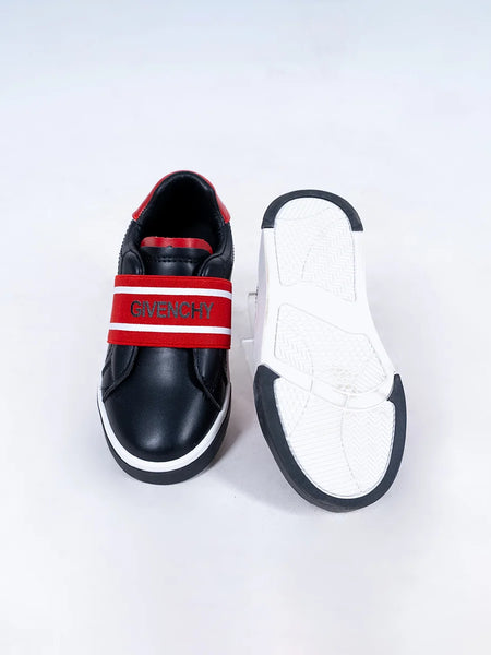 Close-up of trendy boys' black sneakers with red logo detailing and flexible sole, Jaipur