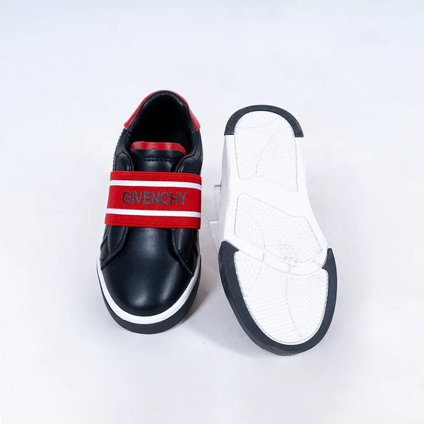 Close-up of trendy boys' black sneakers with red logo detailing and flexible sole, Jaipur