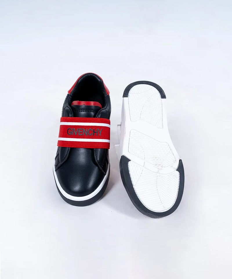 Close-up of trendy boys' black sneakers with red logo detailing and flexible sole, Jaipur