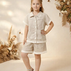 Young girl in a beige outfit with floral decorations in the background