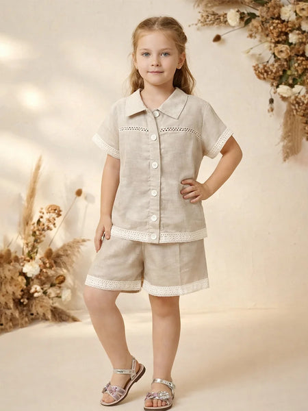 Young girl in a beige outfit with floral decorations in the background