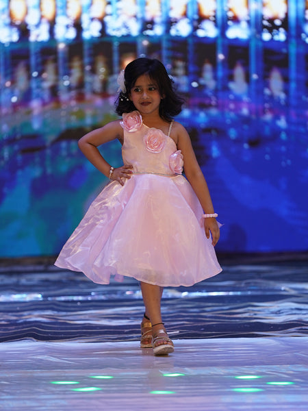 This is a beautiful baby pink coloured kids birthday frock that comes with a back zip closure. It features cute floral detailing on the dress that adds grace to the look.