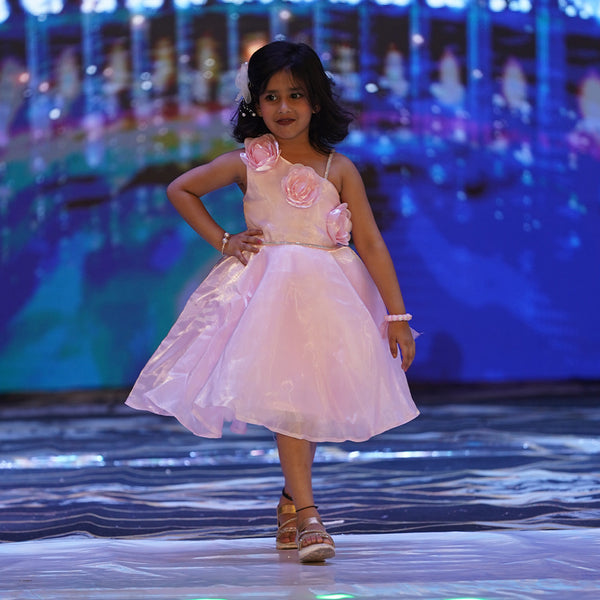 This is a beautiful baby pink coloured kids birthday frock that comes with a back zip closure. It features cute floral detailing on the dress that adds grace to the look.