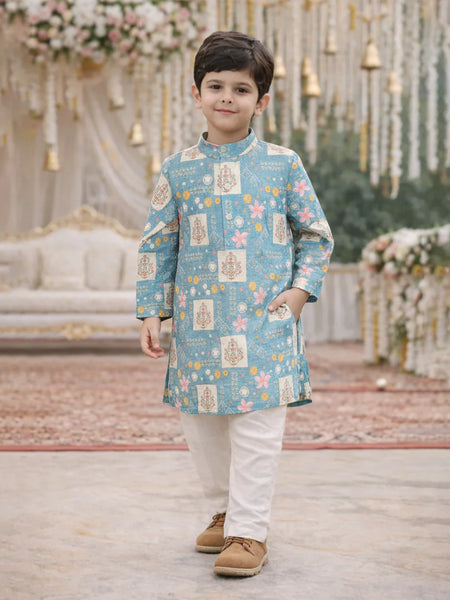 Child wearing a blue patterned kurta with white pants in a decorated indoor setting