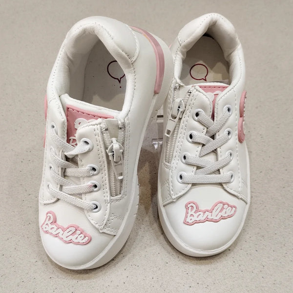 White sneakers with pink accents and 'Barbie' branding on a beige background