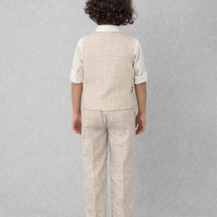 Child wearing a beige checkered vest and pants set on a gray background