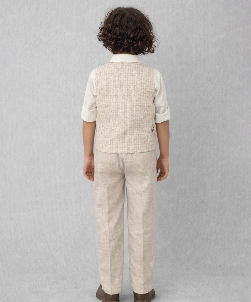 Child wearing a beige checkered vest and pants set on a gray background