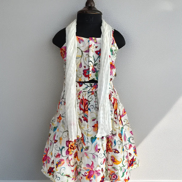 Floral dress with a white scarf on a mannequin against a plain background