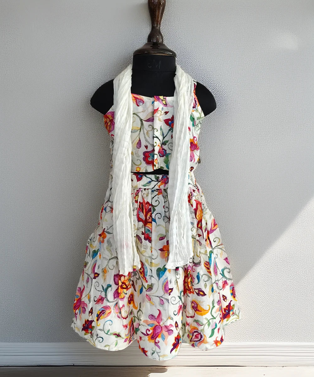 Floral dress with a white scarf on a mannequin against a plain background