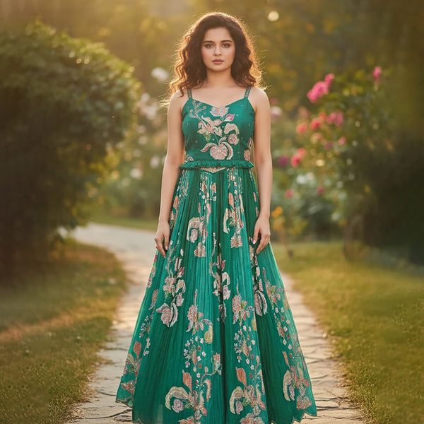 Woman in a green floral dress standing on a path with blurred background
