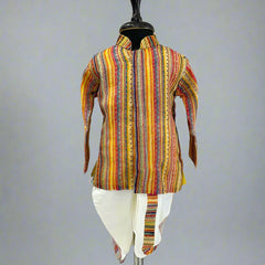 A multicolored striped kurta pyjama set displayed on a mannequin against a wooden backdrop.