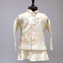 A cream color kurta jacket set displayed on a mannequin, consisting of a jacket with floral embroidery and a pair of shorts.