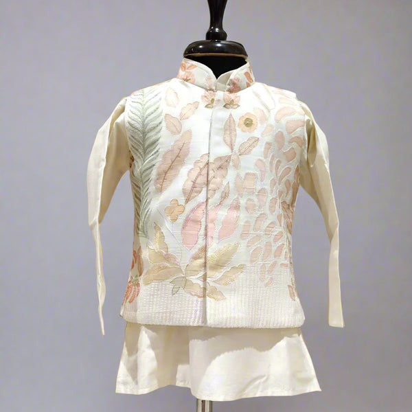 A cream color kurta jacket set displayed on a mannequin, consisting of a jacket with floral embroidery and a pair of shorts.