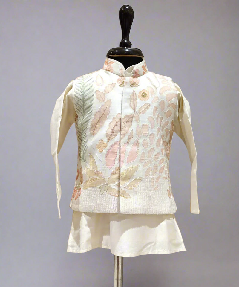 A cream color kurta jacket set displayed on a mannequin, consisting of a jacket with floral embroidery and a pair of shorts.