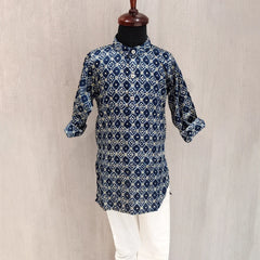 Blue patterned kurta with white pants on a mannequin against a beige background