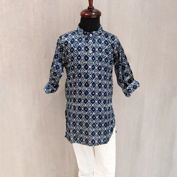 Blue patterned kurta with white pants on a mannequin against a beige background