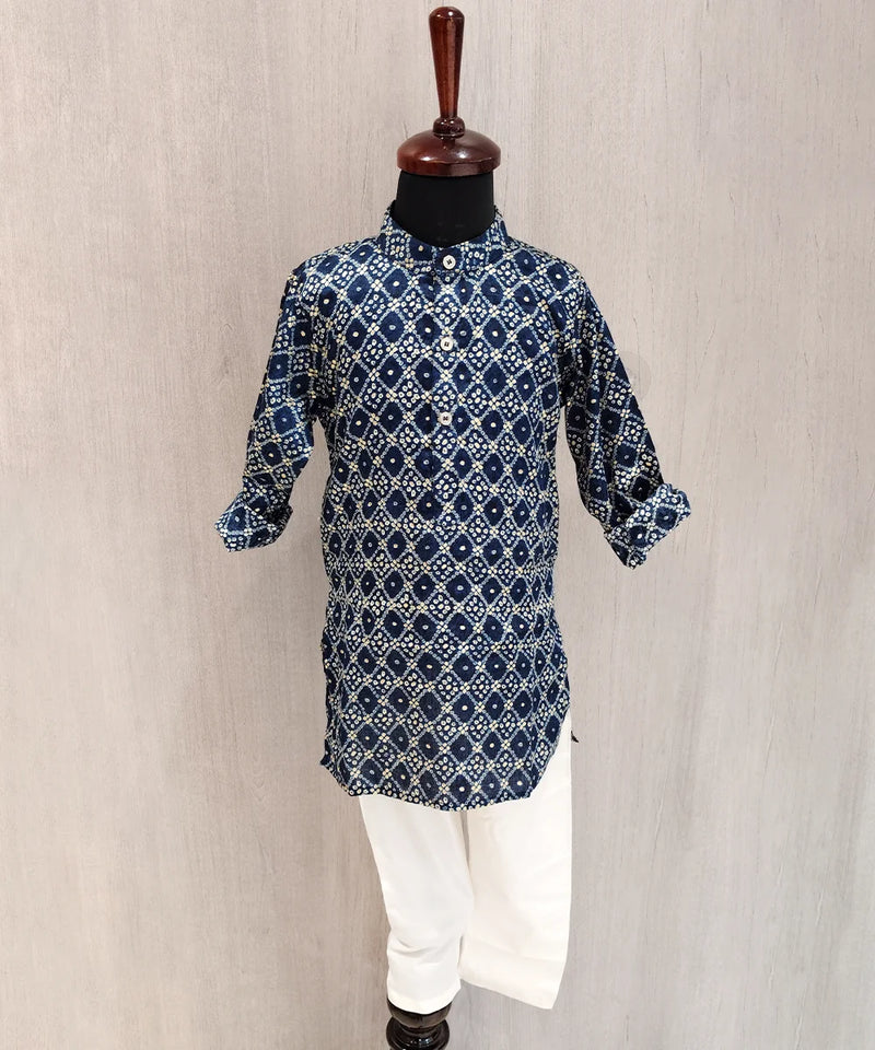 Blue patterned kurta with white pants on a mannequin against a beige background