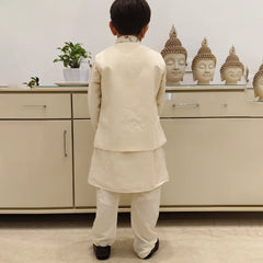 It is a back view of the boy wearing a cream colour kurta pyjama. The back of the jacket is plain.