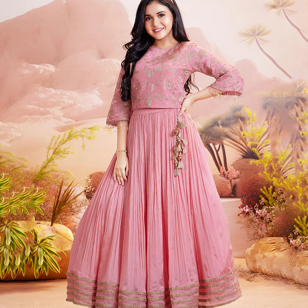 A young girl wearing a gold zari-embroidered lehenga 