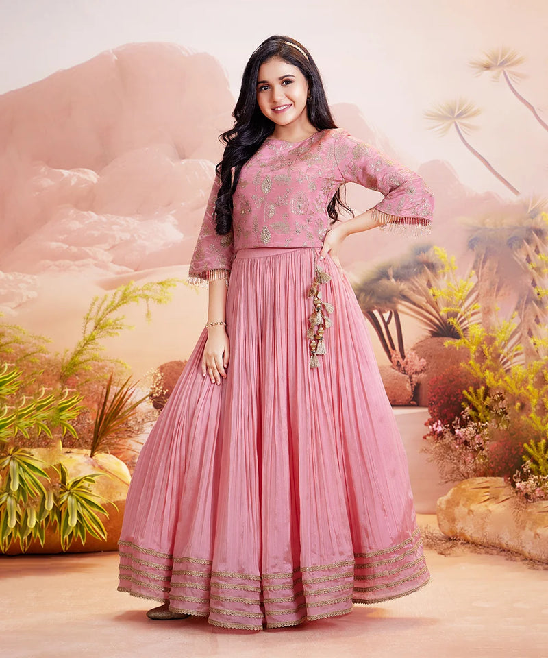 A young girl wearing a gold zari-embroidered lehenga 