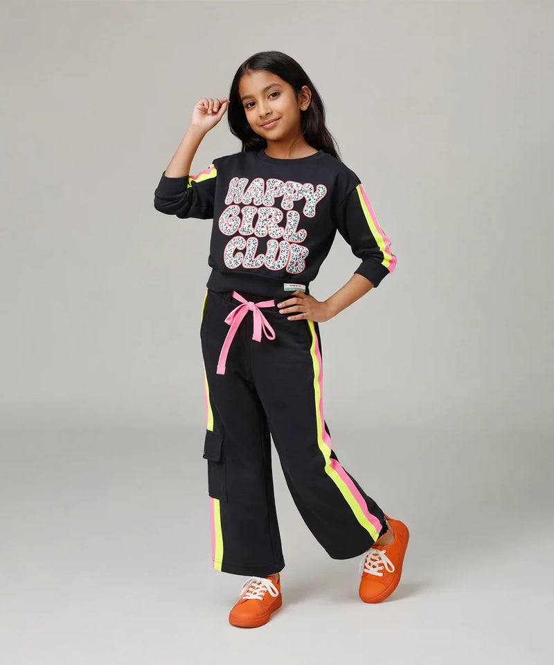 Girl wearing a black 'Happy Girl Club' outfit with colorful accents on a gray background