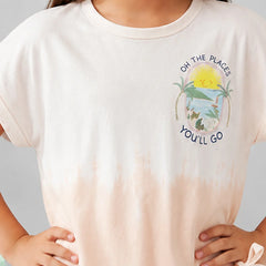 A close-up of a person wearing a short-sleeve crew-neck T-shirt. The shirt is off-white at the top and fades into a very light peach-pink at the bottom, with a colorful beach graphic and the text 'ON THE PLACES YOU'LL GO' printed on the left chest.