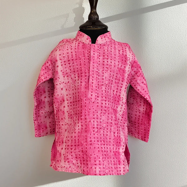 Pink patterned jacket on a mannequin against a white wall
