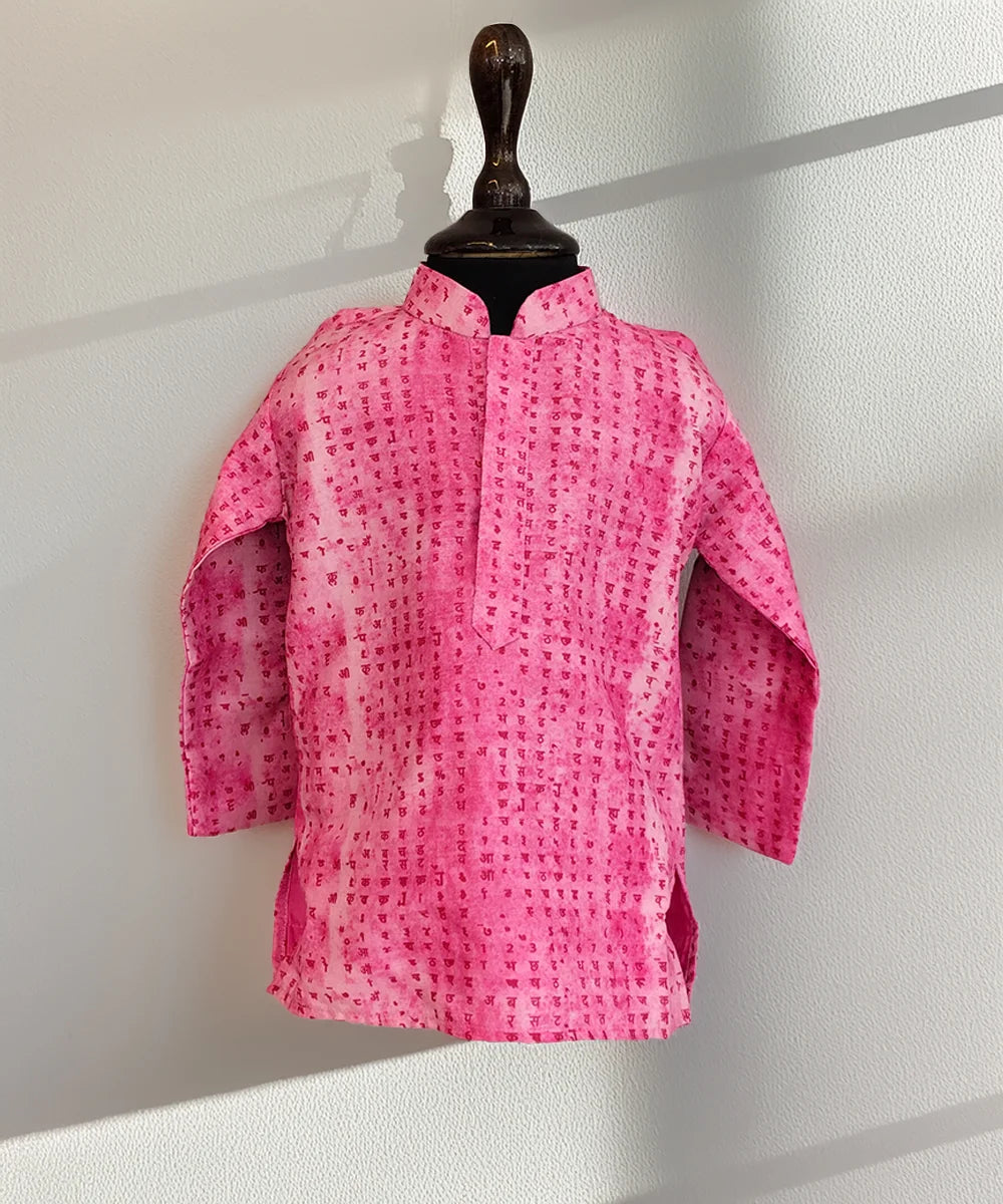 Pink patterned jacket on a mannequin against a white wall