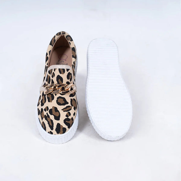 Close-up of trendy girls' slip-on sneakers with leopard pattern and metallic chain, Jaipur