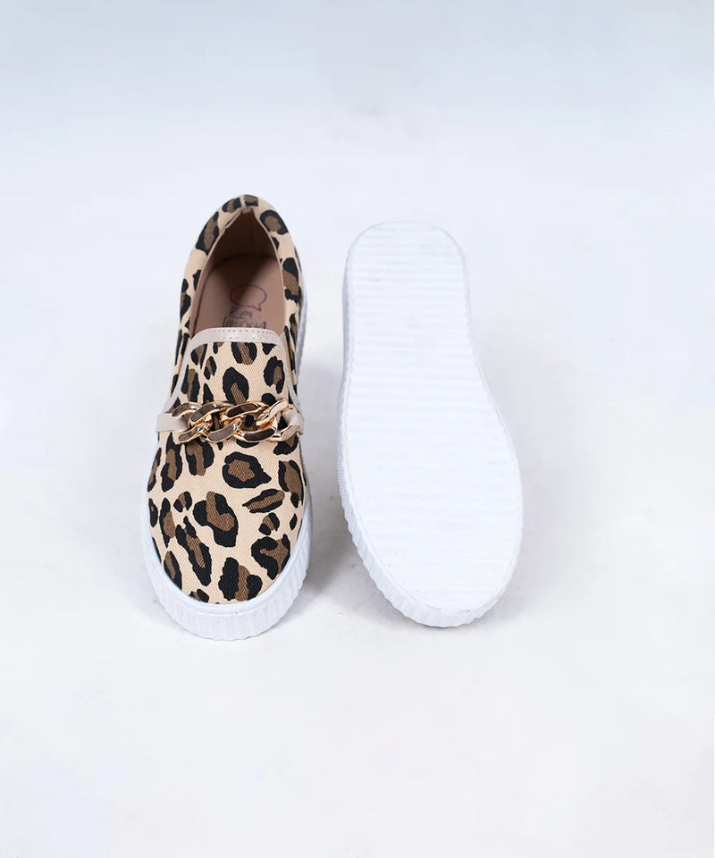 Close-up of trendy girls' slip-on sneakers with leopard pattern and metallic chain, Jaipur