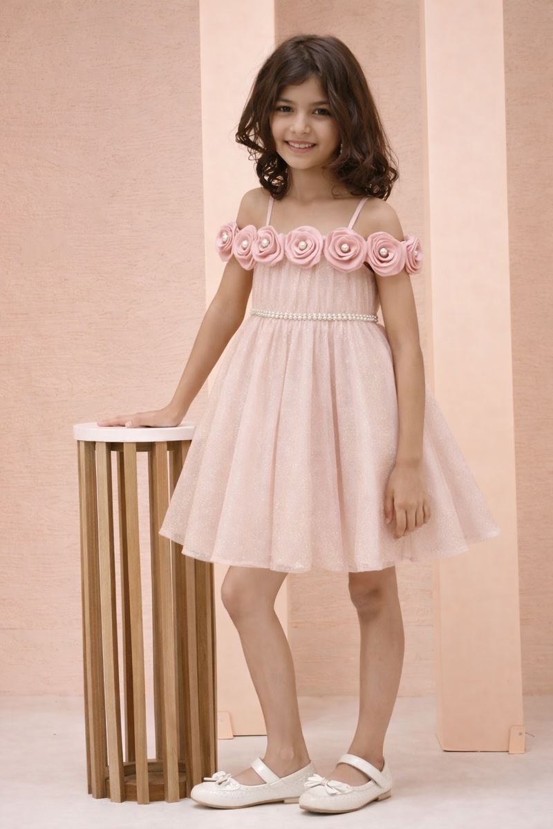 Young girl wearing a pink dress with floral straps against a beige background
