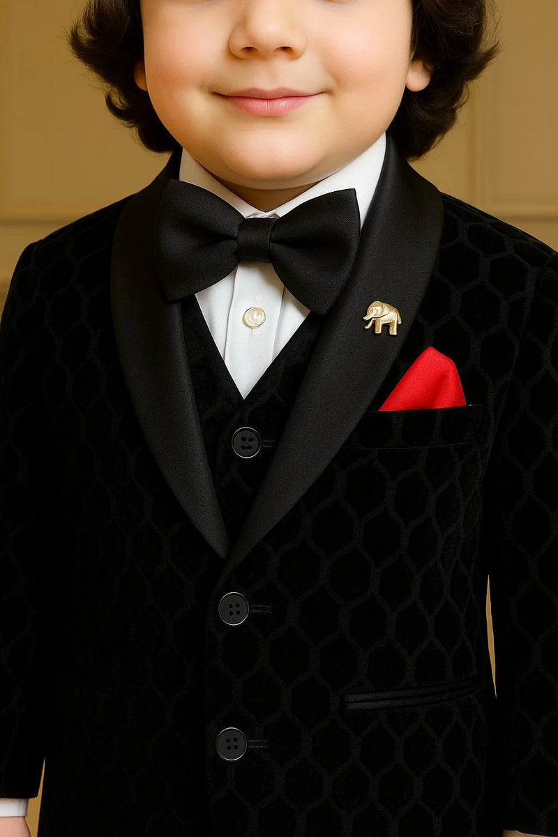 Child wearing a formal black suit with a bow tie and red pocket square.
