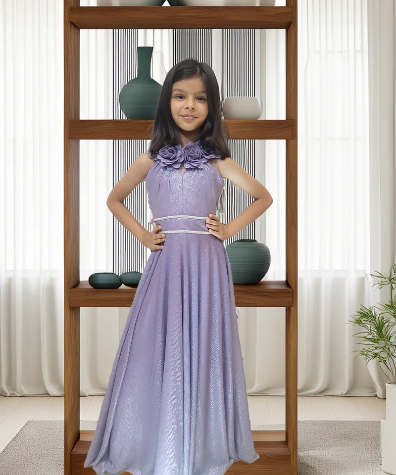 Young girl in a purple dress standing in front of a wooden shelf with decorative vases.