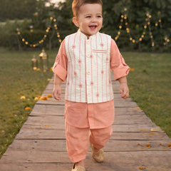 Child in traditional outfit walking on a wooden path with decorative lights in the background