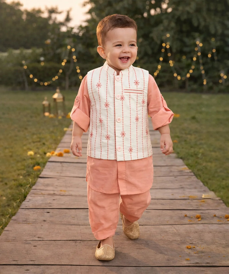 Child in traditional outfit walking on a wooden path with decorative lights in the background
